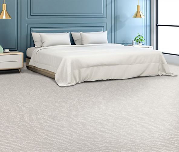 Large bedroom with white tone patterned carped and blue trim walls