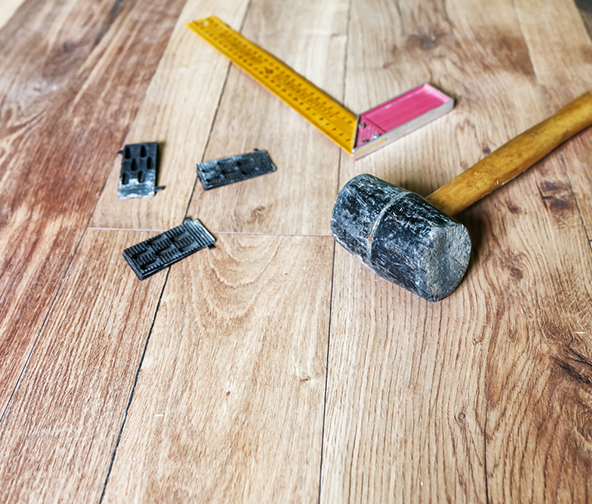 Tools of the flooring trade atop some freshly installed hardwood