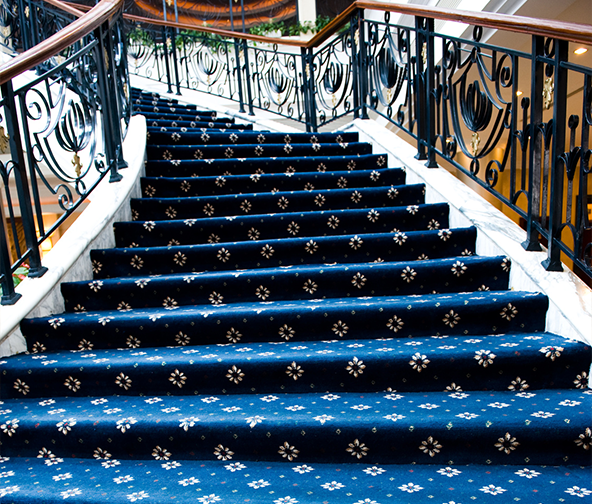 Beautiful patterned blue carpeted stairway