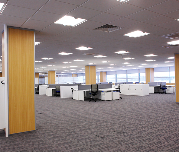 Large open office space with wood panel pillars