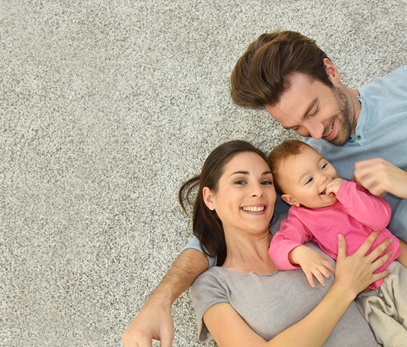 Family laying down on their soft new carpet