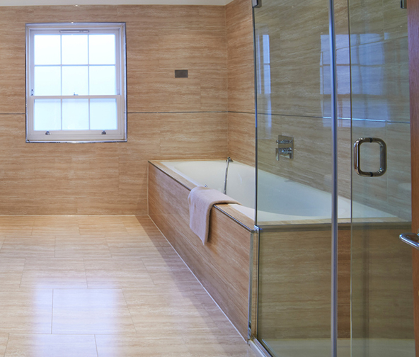 Wood grain tile flooring, walls, and bath surround in modern space