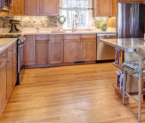 Classic kitchen space with medium tone wood flooring