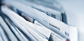 A stack of news papers with the World Business page visible