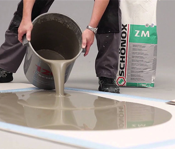 Pouring out material in a flooring installation